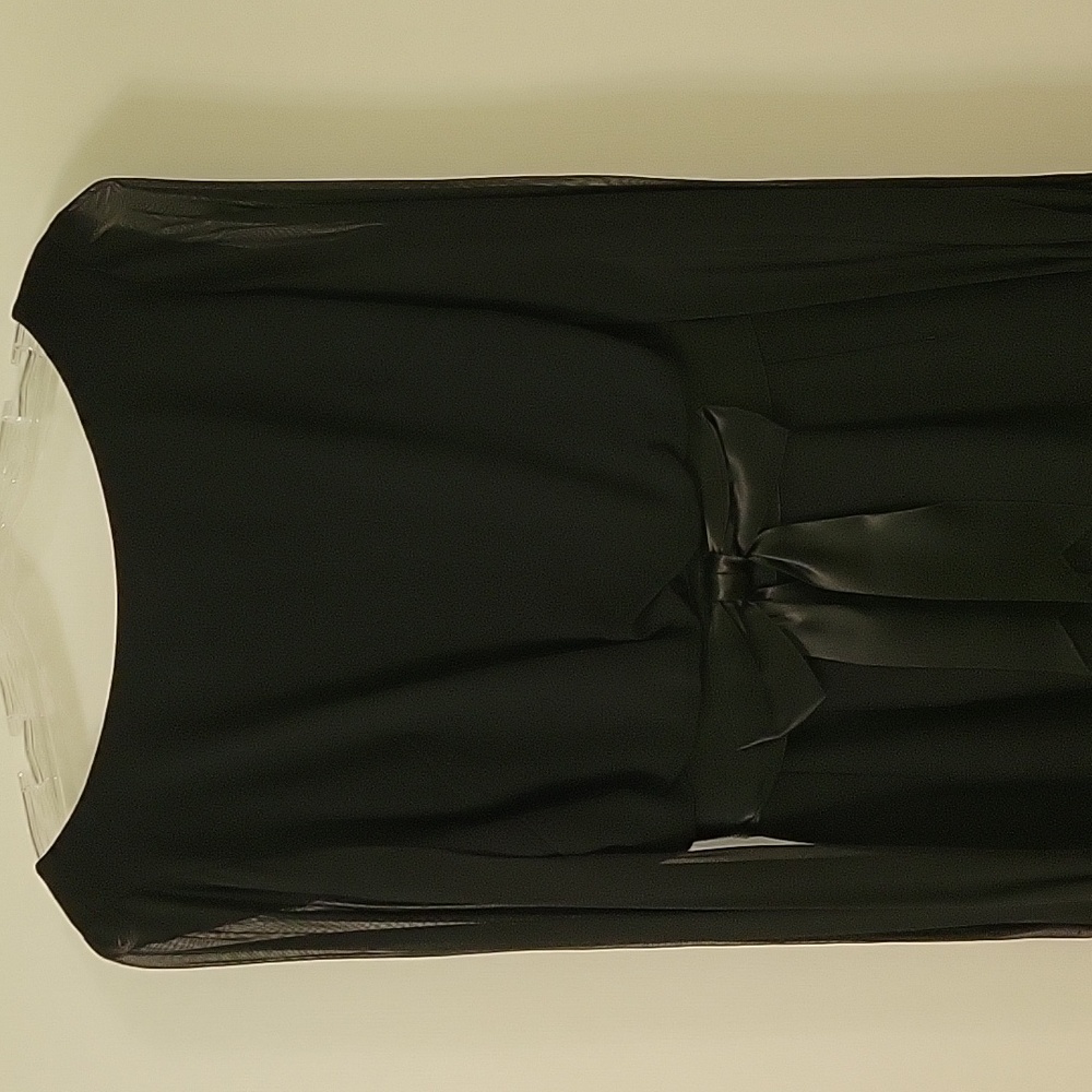 Black crepe/satin dress with long sheer sleeves. Size is 4 to 6.